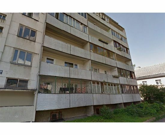 "Mazģimenes" daudzdzīvokļu mājas fasāde ar dažādiem logiem un balkoniem renovācijas vajadzībām.